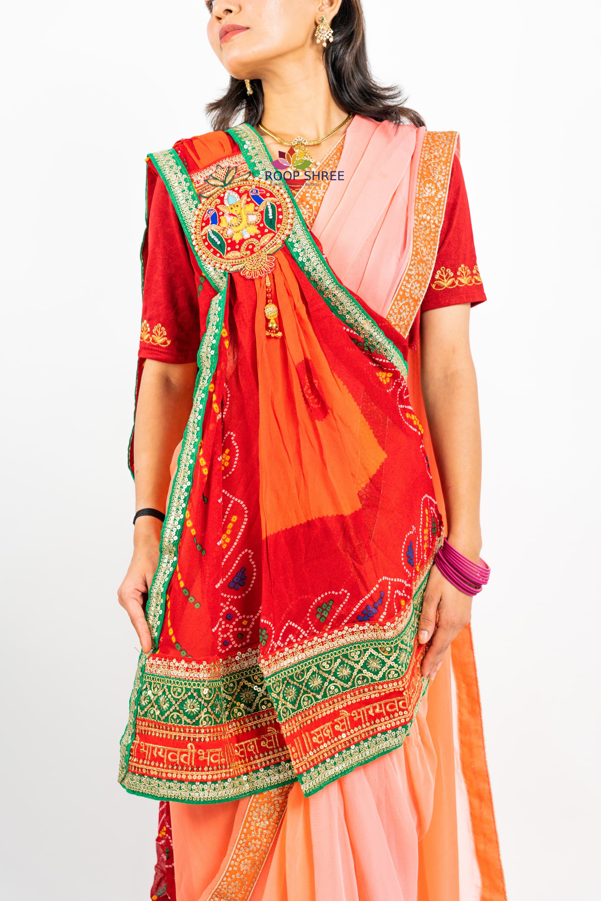Traditional odhna adorned with  Ganesh brooch for divine elegance.