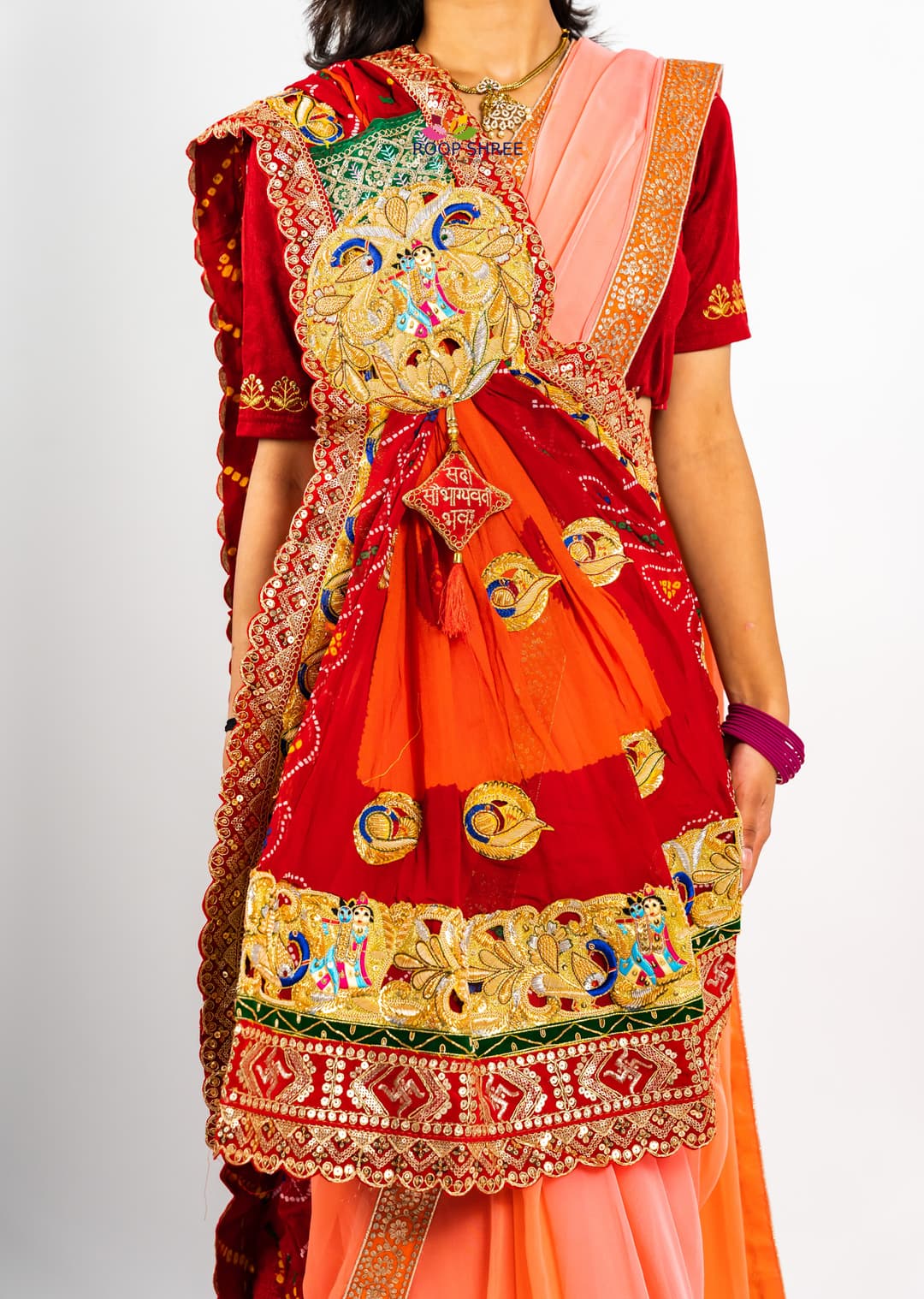 Traditional odhna adorned with Radha Krishna brooch for divine elegance.
